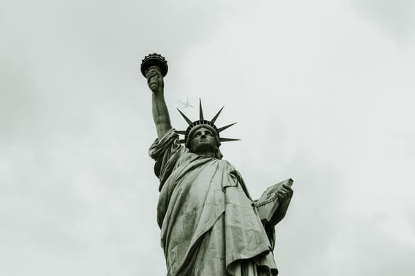 The Statue of Liberty against a cloudy sky